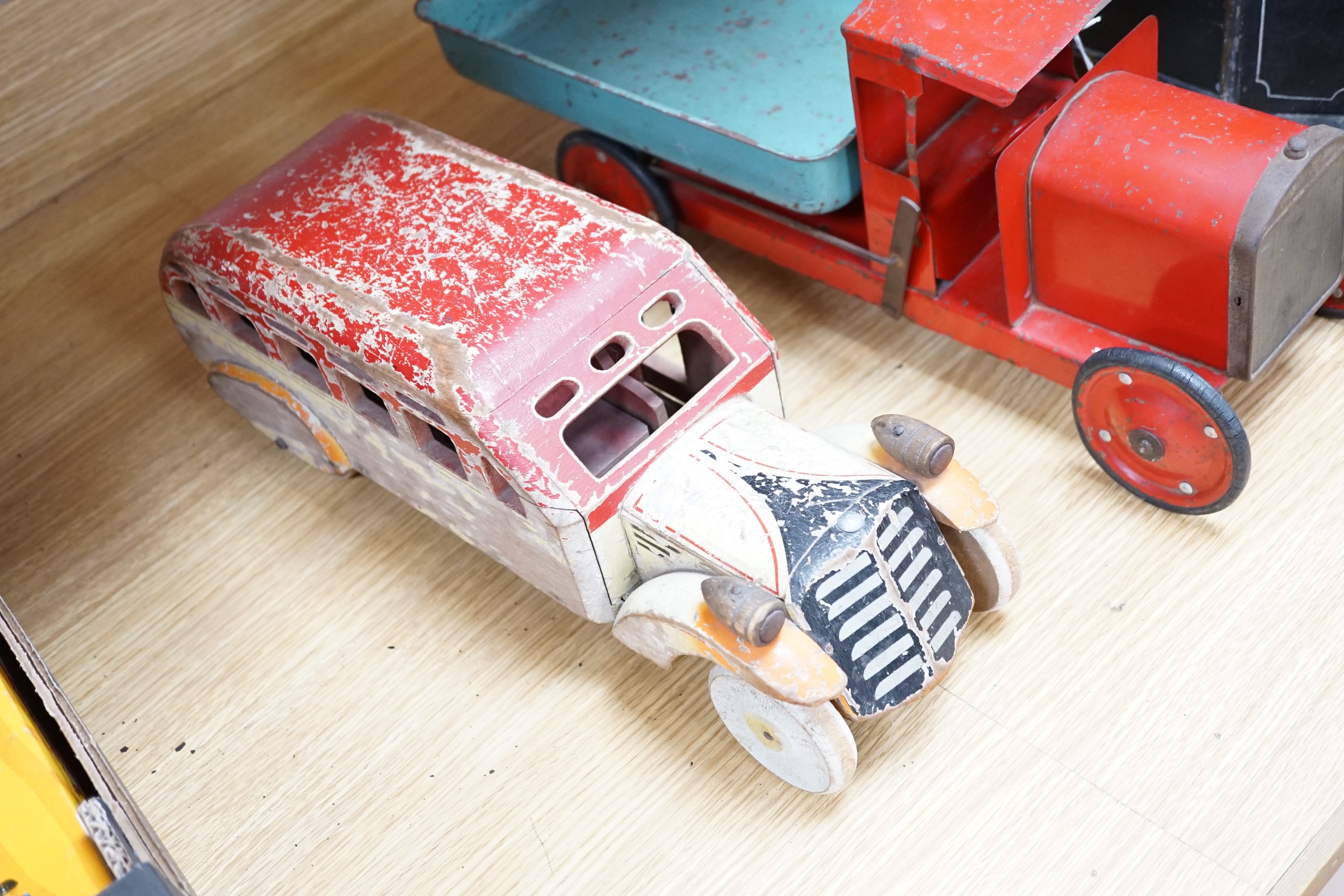 Three model vehicles including; a tinplate Tri-ang tipper lorry, a Pickfords removal van (believed to have been used as a shop window display) and a wooden bus, length of Pickfords van 54cm